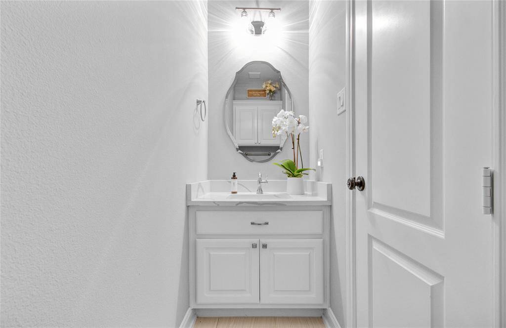 Chic and inviting half bath with modern fixtures and elegant design.