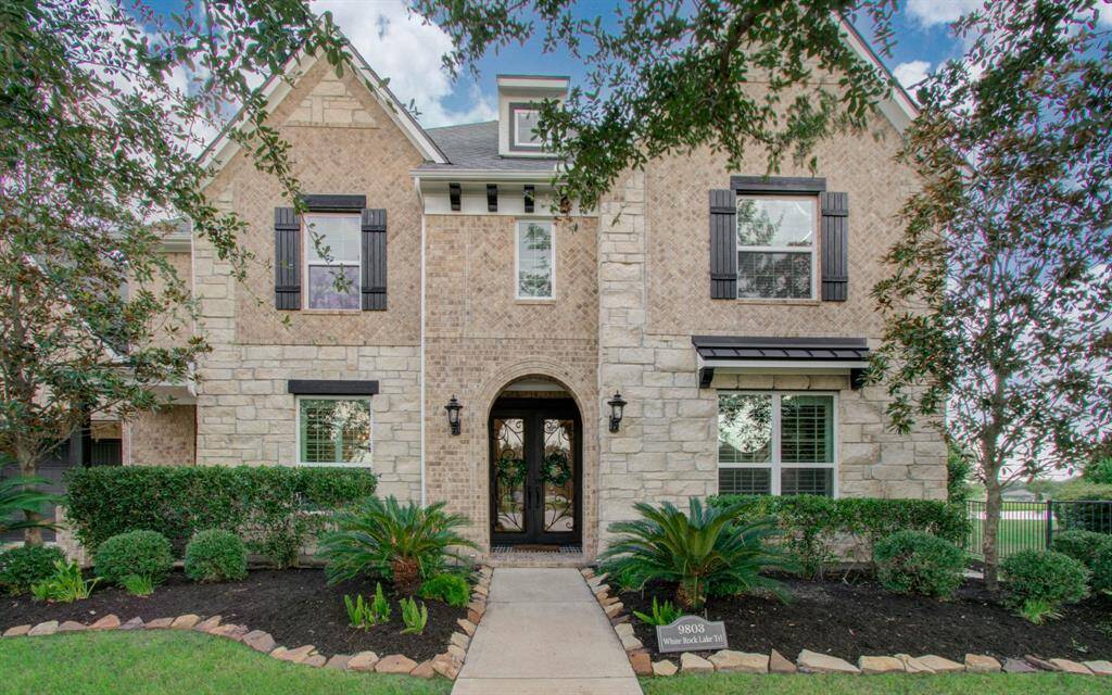 Welcome Home! This two-story home with a stone facade, featuring a well-manicured front yard, mature trees and plenty of room to add your special touches.
