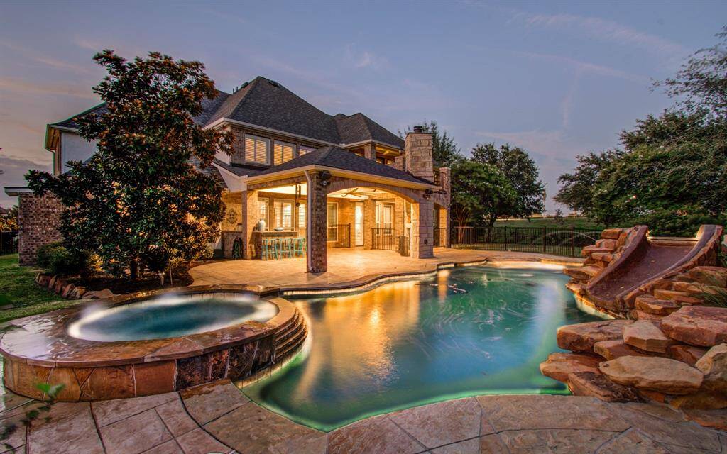 Experience your private paradise with a stunning pool, relaxing hot tub, and fun slide.