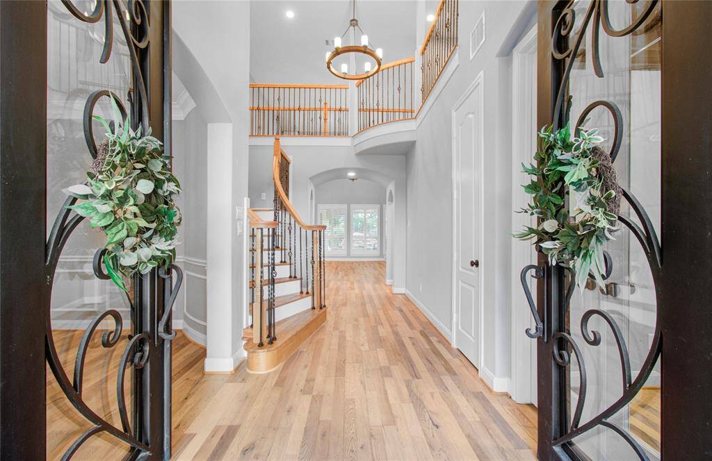 Majestic double iron door entryway welcomes you into a spacious and elegant foyer.