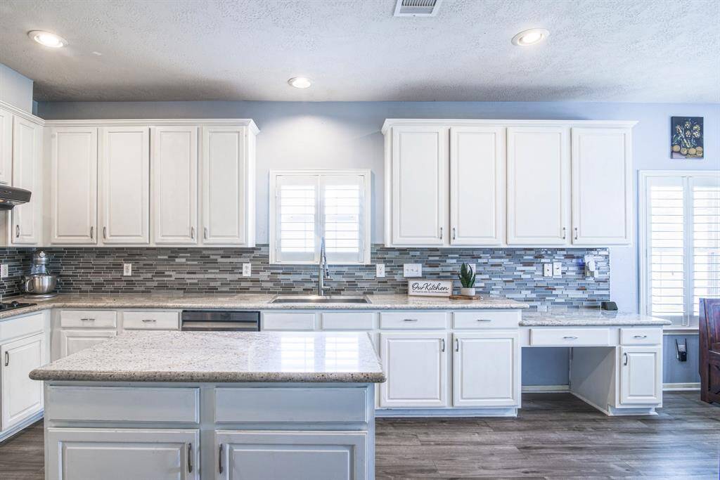 The kitchen is large freshly updated with white painted cabinets and beautiful granite countertops.