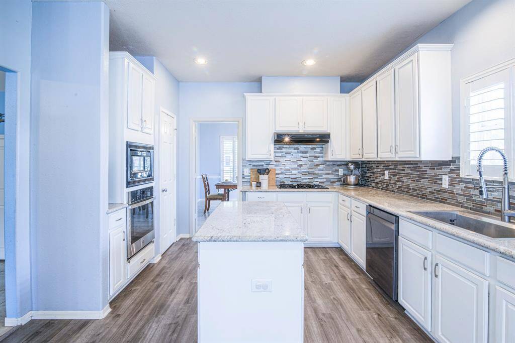 Waterproof plank flooring  is elegant and functional, and is found throughout the home.