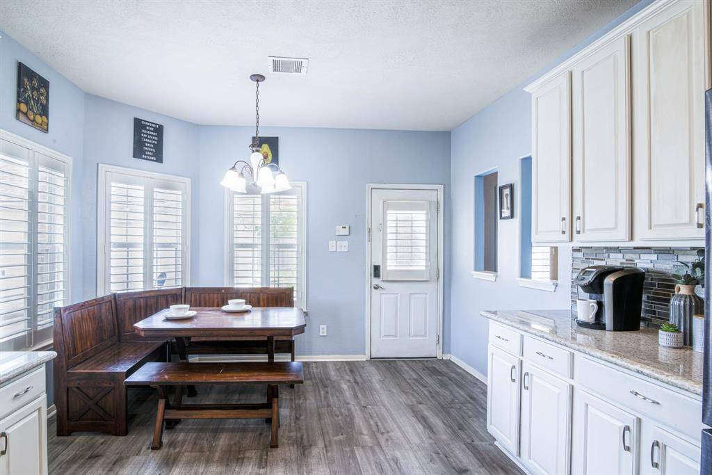 The large breakfast room is attached to the kitchen, and also has a door leading to the backyard.
