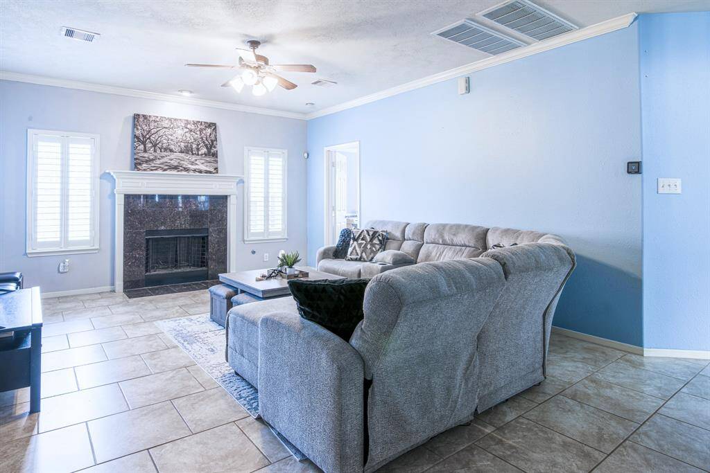 The family room overlooks the backyard and has access directly to the primary bedroom. The wood-burning fireplace is a focal point and there is a large closet for storage in the hallway to the kitchen.