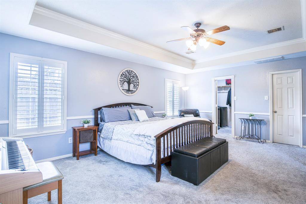The walk-in closet has two entrances and the washer and dryer conveniently located on one side.