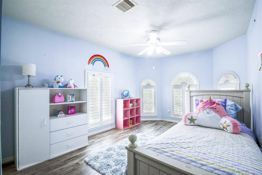 Bedrooms 3 and 4 each have large closets and ceiling fans, and are connected to a large shared bathroom.