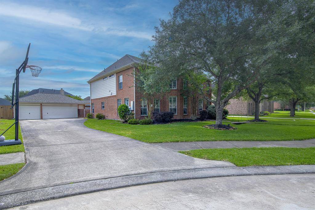 The long driveway leads to an oversized 3-car garage.