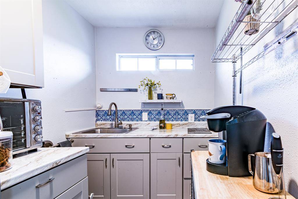 The kitchenette for the independent suite is built where the original laundry room was located. It could be quickly converted back to a utility room if a new owner preferred that use.