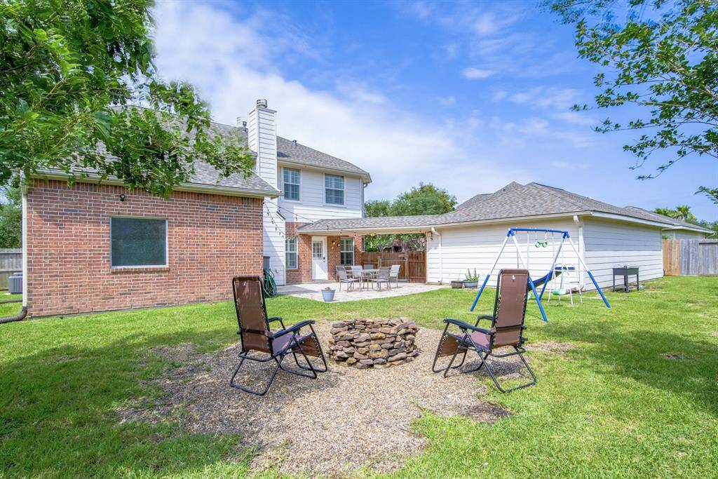 Rear view of the backyard and 3-car garage.