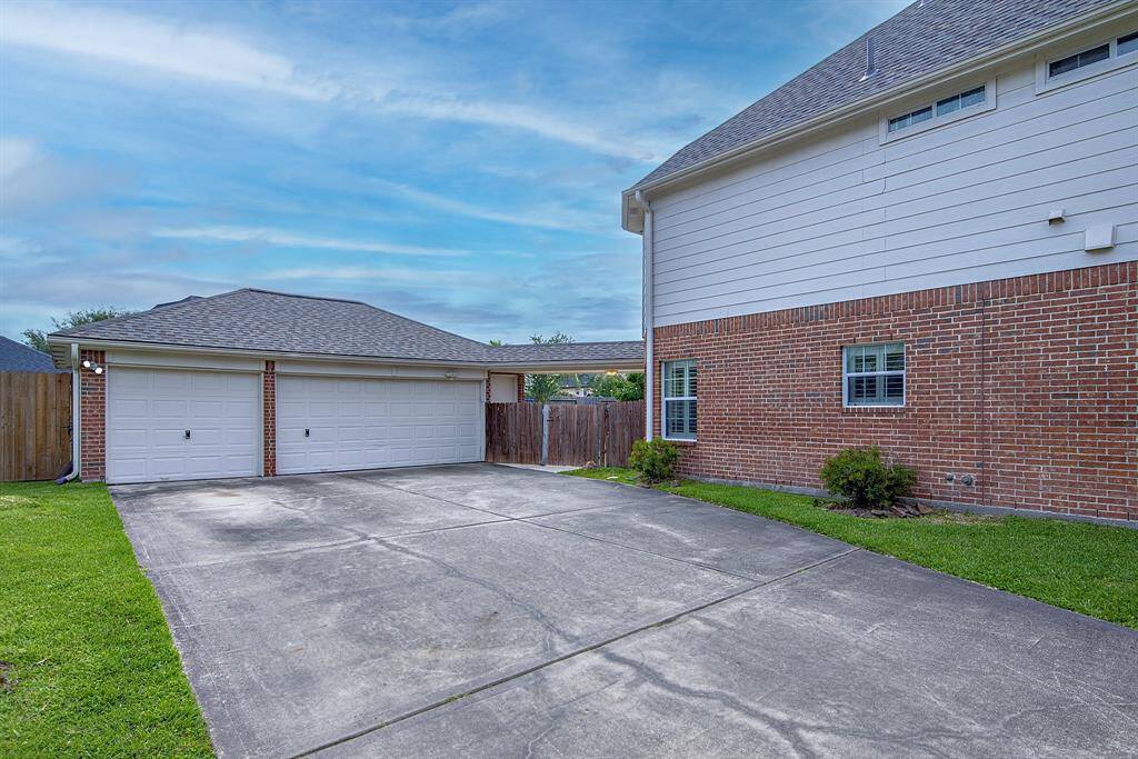 The large garage and driveway provides plenty of space for parking and entertainment.
