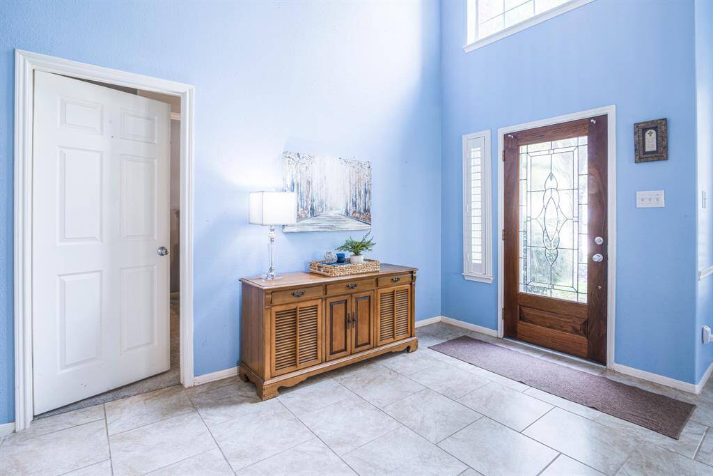 A beautiful entryway welcomes you to the grand two-story living room.