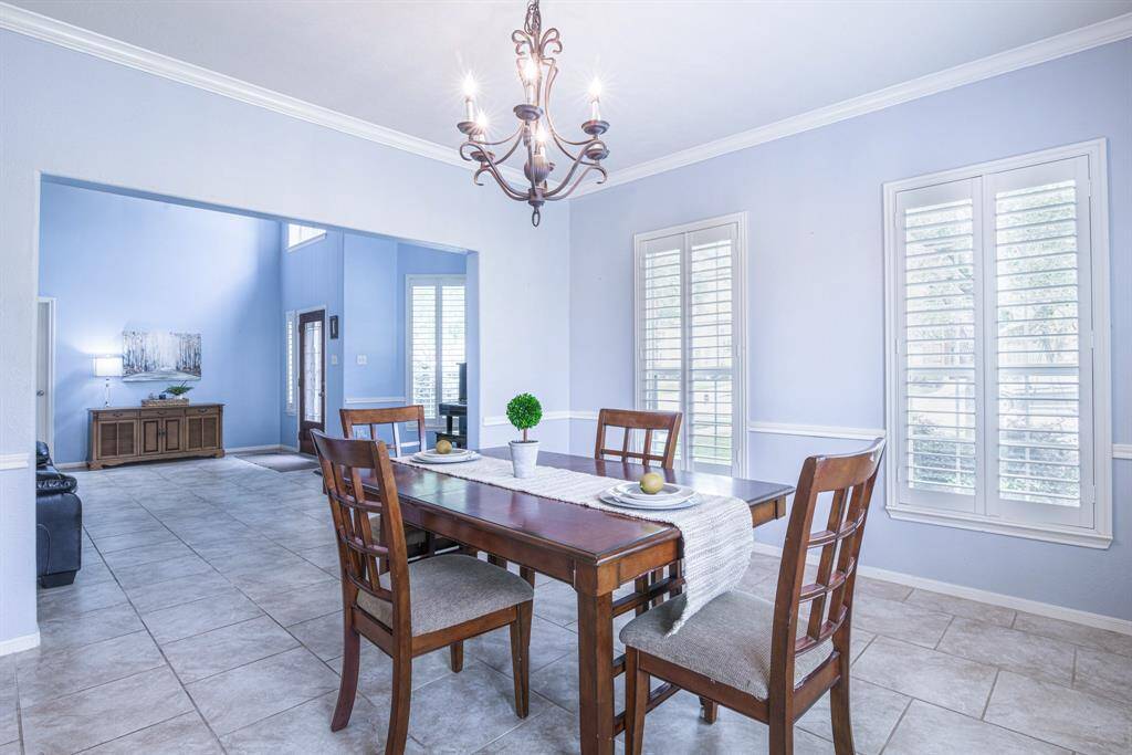 Crown molding and updated light fixture define this elegant dining space.