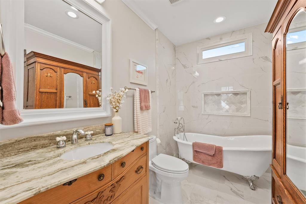 Full guest bathroom is beautifully updated with clawfoot tub.