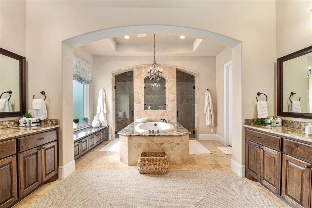 The master bathroom is an oasis of luxury. Featuring dual vanities and two walk-in closets, this space is designed for ultimate comfort and convenience.