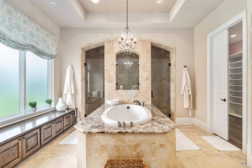 The master bathroom, bathed in natural light, offers the perfect retreat for relaxation and pampering.
