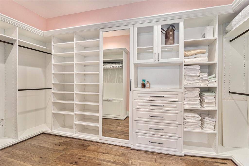 Second walk in closet elegantly designed to keep your wardrobe organized.