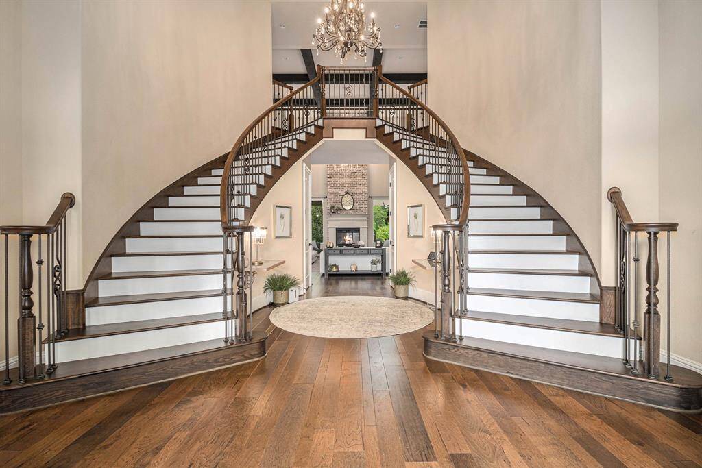 Step onto the large gallery entryway featuring a magnificent double-sided grand staircase.