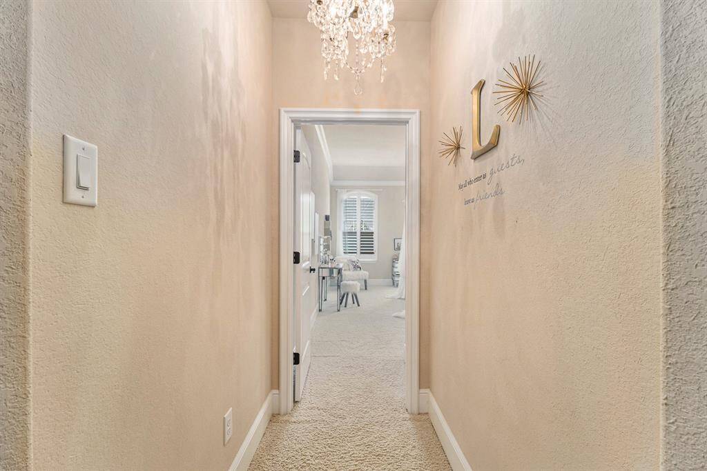 A welcoming entrance hallway leads the way to the secondary room, creating a seamless flow to it.