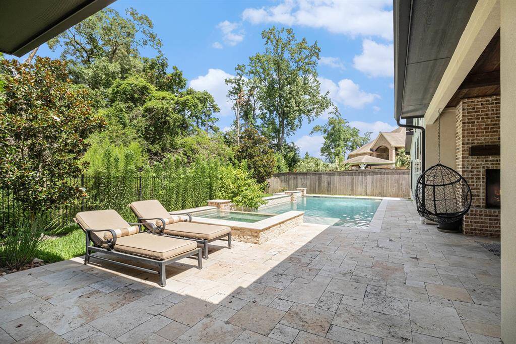 Enjoy the modern pool and spa, which backs to a serene greenbelt.