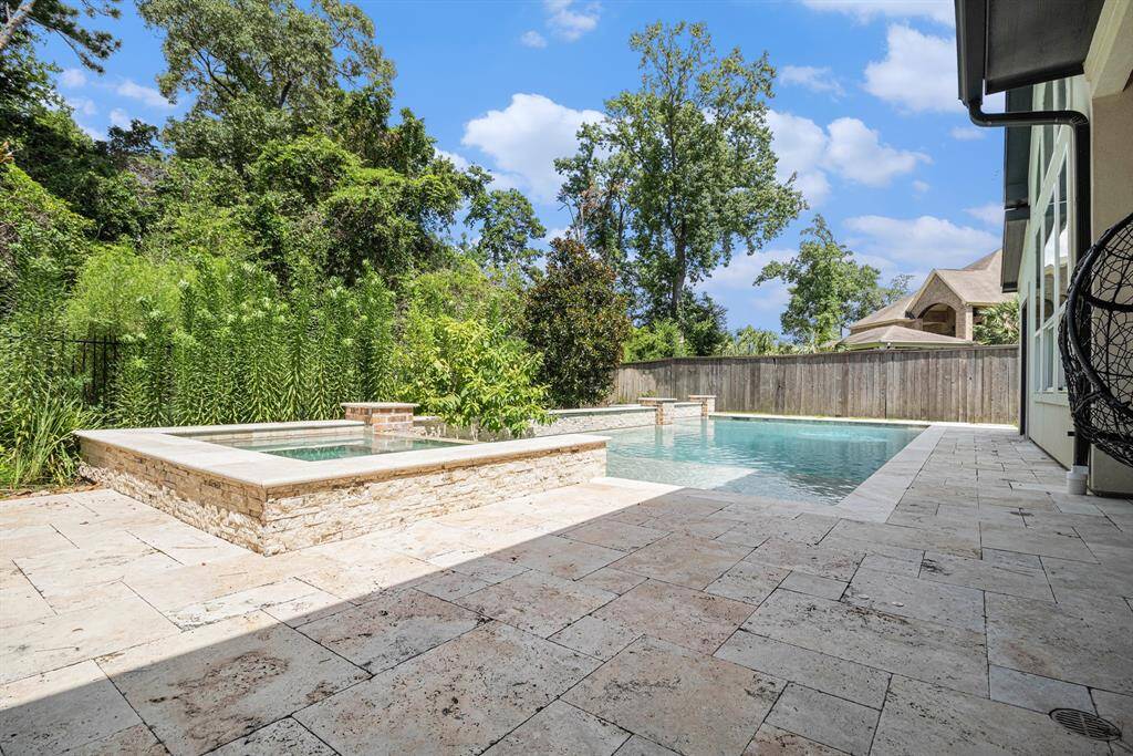 Enjoy the privacy and and beautiful green scenery while relaxing or taking a plunge in the modern pool and spa.