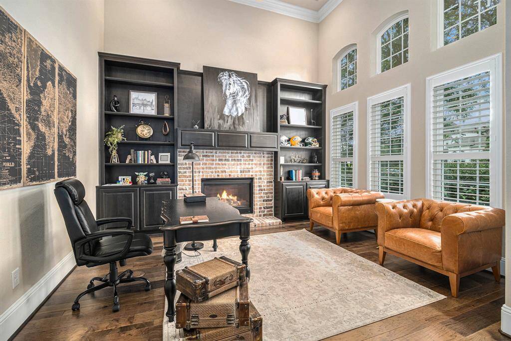 Enjoy working from home in the beautifully designed office featuring tall ceilings and built-in cabinets and shelving. This space offers a bright and airy environment perfect for working from home.