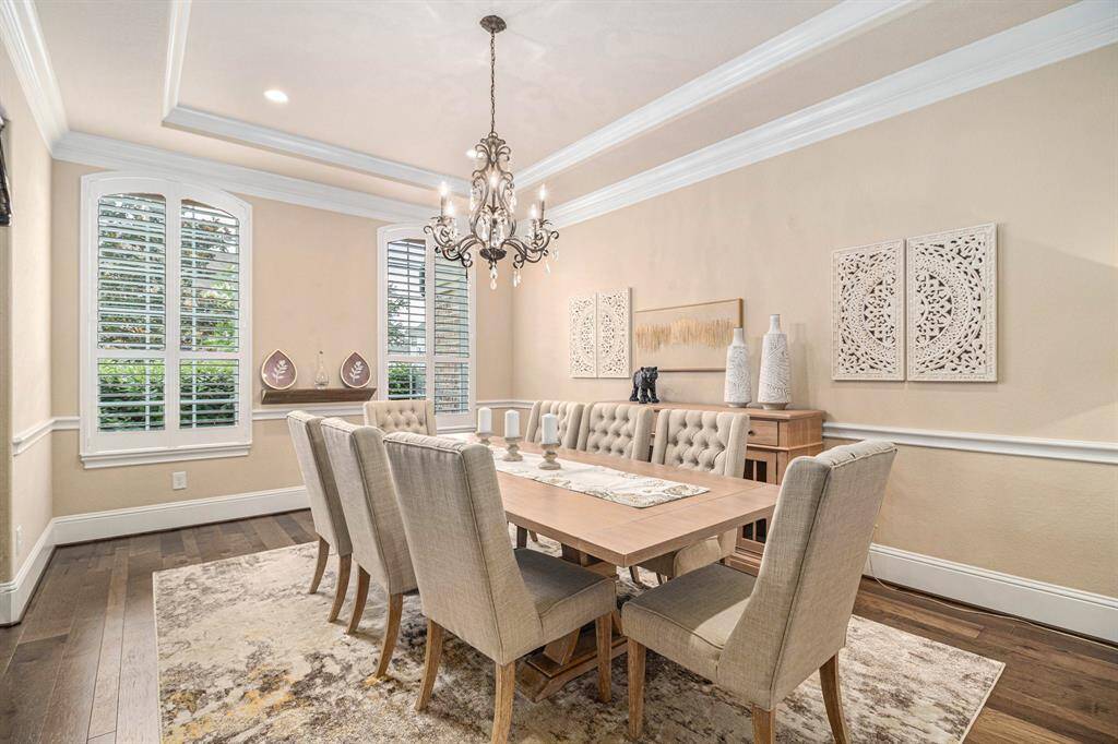 The elegant dining room is seamlessly open to the grand entry hall. This open design creates a welcoming flow and perfect for hosting dinner parties.