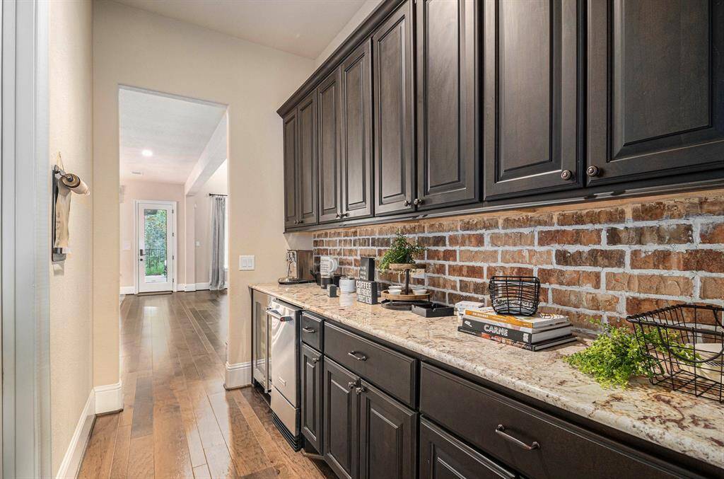 The butler's pantry is equipped with an ice maker and a dual temperature wine refrigerator.