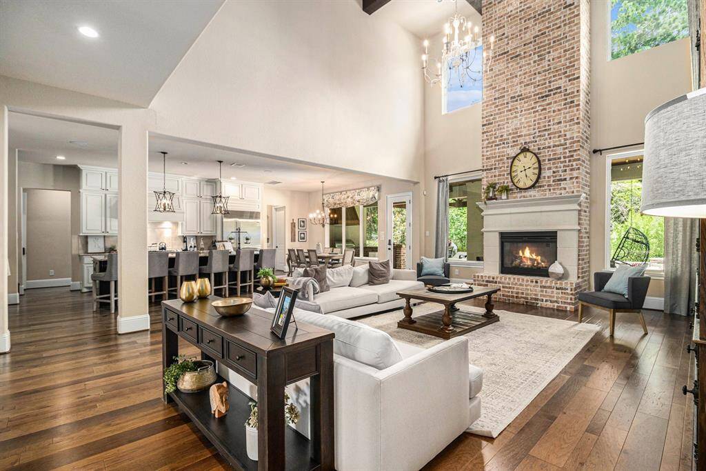 The spacious living room is flooded with natural light creating a warn and inviting atmosphere, open to the kitchen area.