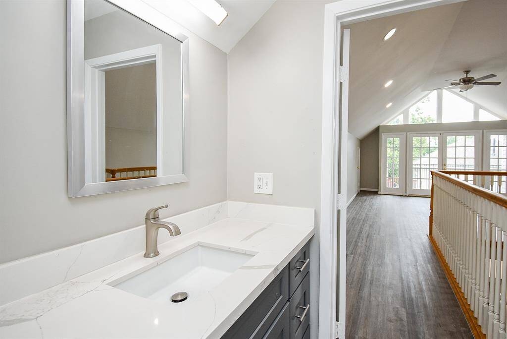 Full-size bathroom featuring modern grey tile and a newly renovated shower.