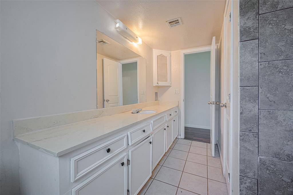 Lots of storage in the secondary bathroom.  On the right is a linen closet.