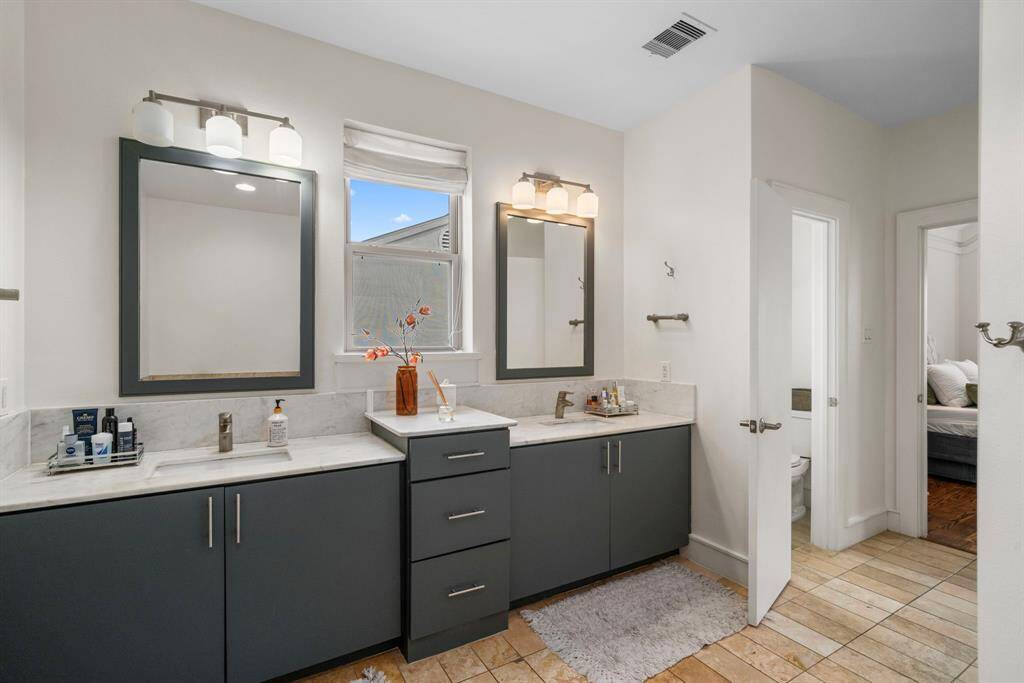 Dual sinks and custom features in this primary bathroom retreat.