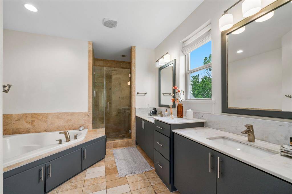 Tub with separate shower and plenty of light coming through.