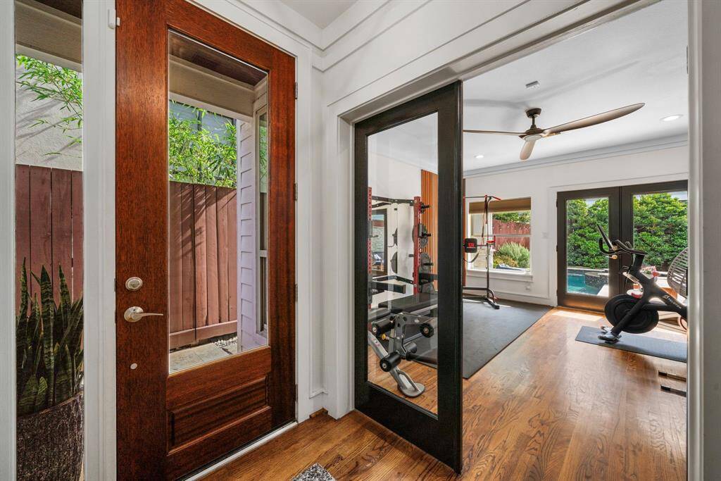 Back to the 1st floor, you'll notice the wide open foyer and access to the 1st floor bedroom suite/office.  Currently used as a workout room but has many uses due to the double glass entry and exit doors.