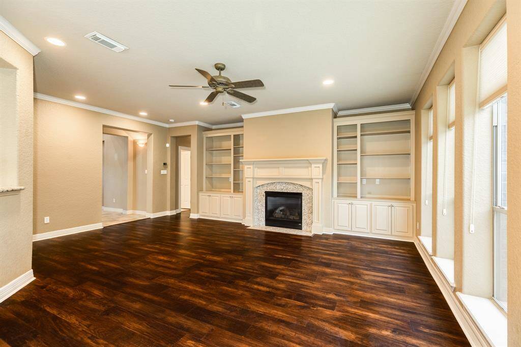 Living room photographed as is.  This space is generous in size and will fit almost any of your furniture comfortably. Imagine holiday decor in all your custom built ins and hanging your holiday decor on the fireplace.
