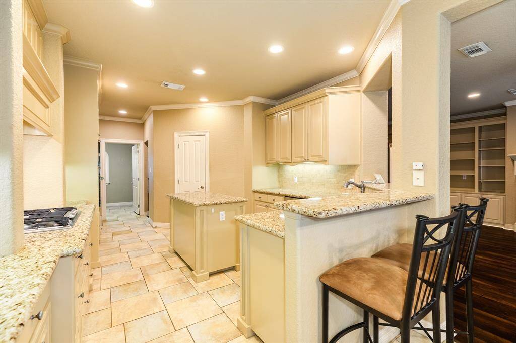 The chef of the home will enjoy this well thought out kitchen. From the gas cooktop to the high end granite lining the counter tops everything on your check list is here. Double ovens and gas fixtures create the ideal cooking situation.