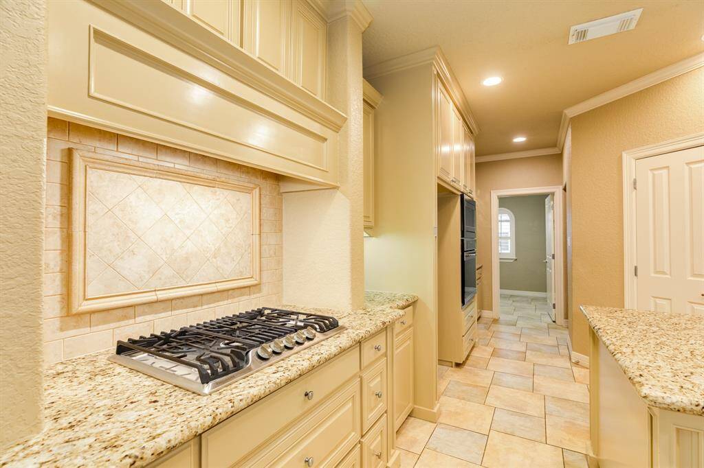 Elevated craftsmanship is showcased throughout this home. From the wood work to the custom tiled backsplash.  Double ovens making it easy to cook for gatherings and holiday dinners. Like a lot of storage in the kitchen? On top of all of the cabinet space this home also offers a large walk in pantry.