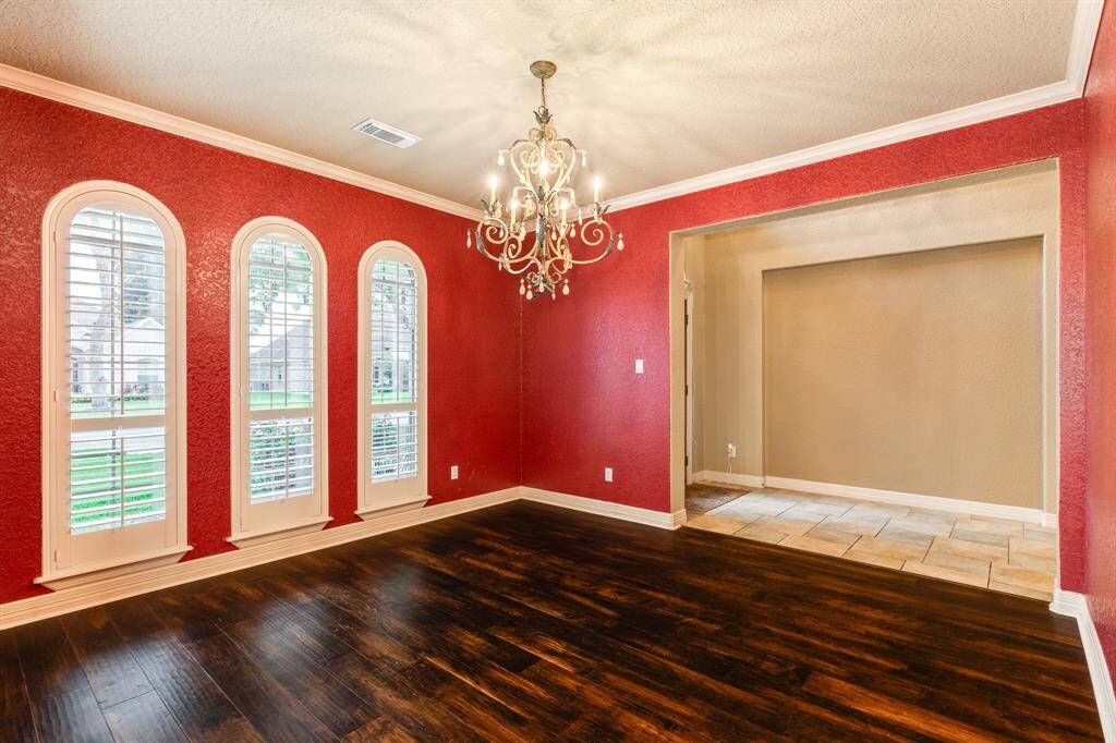 Rich warm wood floors along with custom lighting create a very warm and inviting space to entertain and host.  This formal dining offers plenty of space for your larger tables.