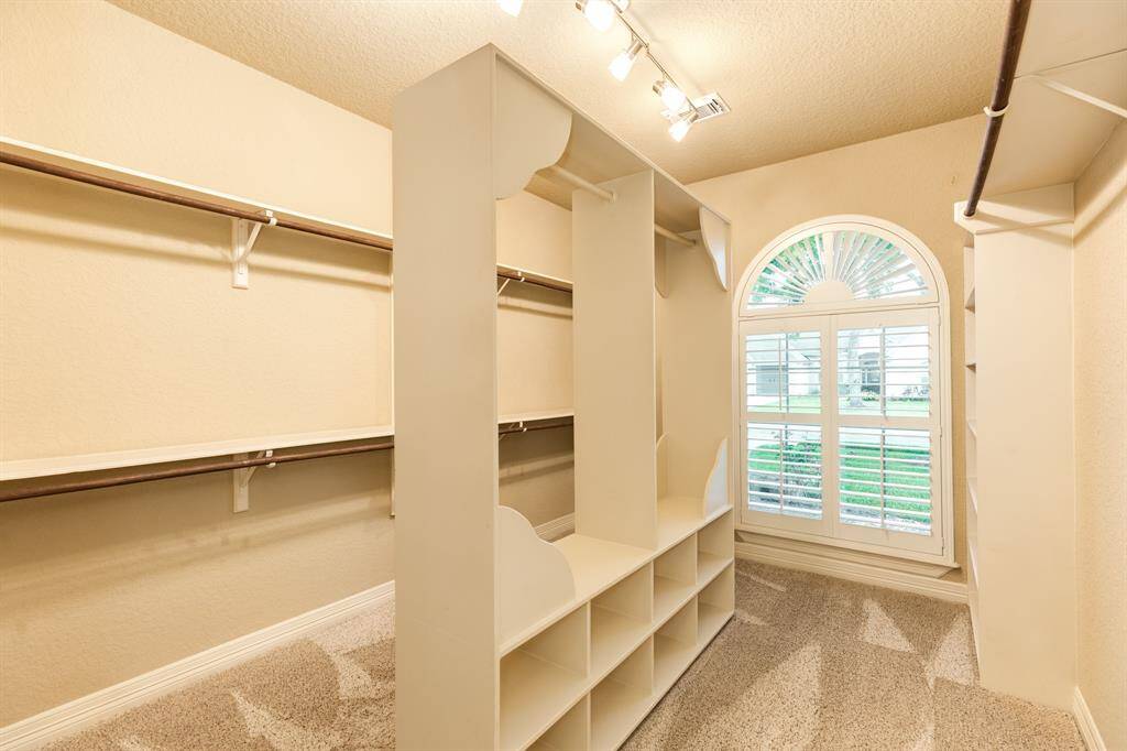 No complaints with this owners closet. The split custom shelving provides functionality for everyone. You want to see this in person!