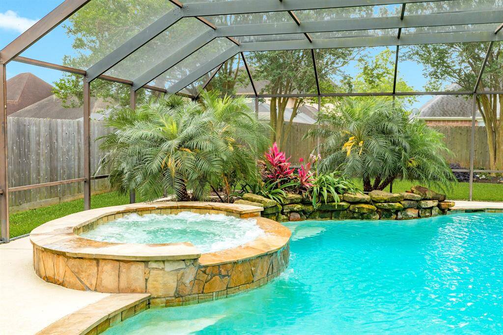 Lush landscaping makes the back yard feel like you're in the tropics. Kick back and relax in your resort style pool.