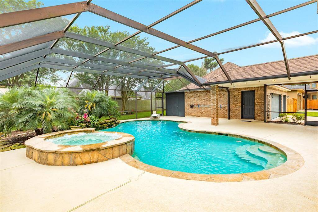 Tons of decking around this pool for plenty of out door furniture.  Extra storage behind the garage for all outdoor and pool equipment.