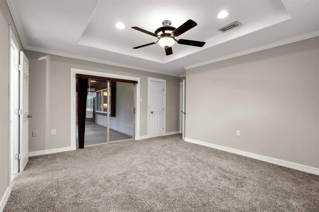 Primary bedroom with access to closed patio.