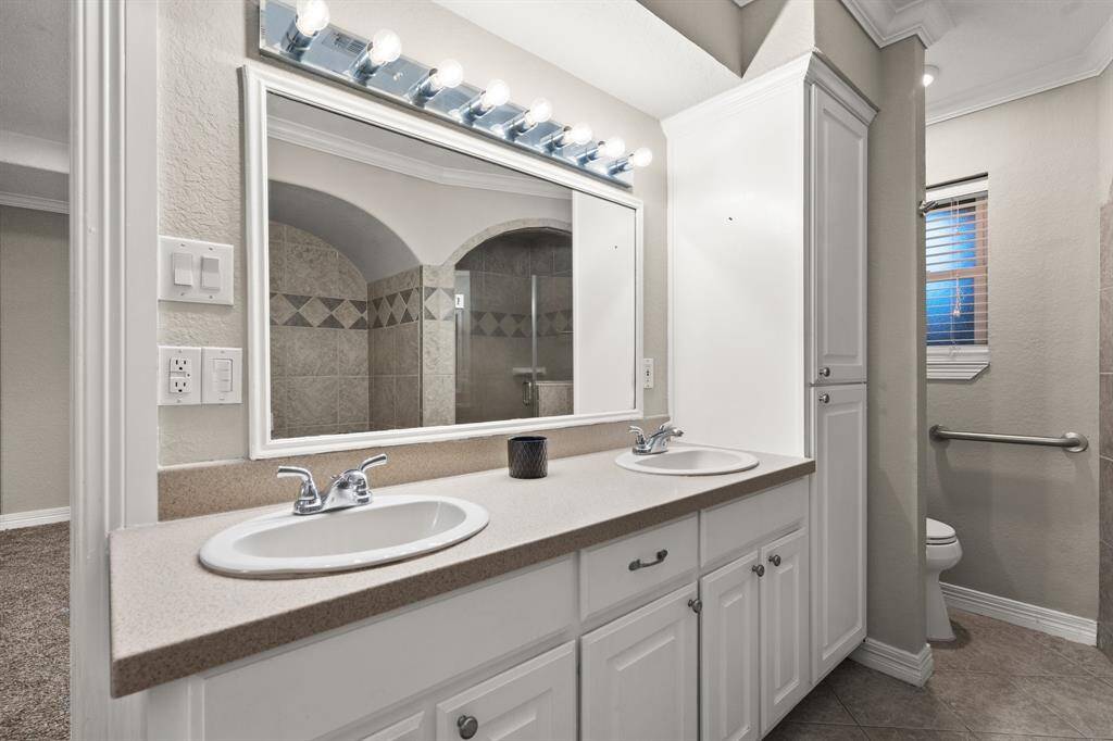 Primary en suite bathroom has double sinks plus an additional separate vanity area with mirror, not shown.