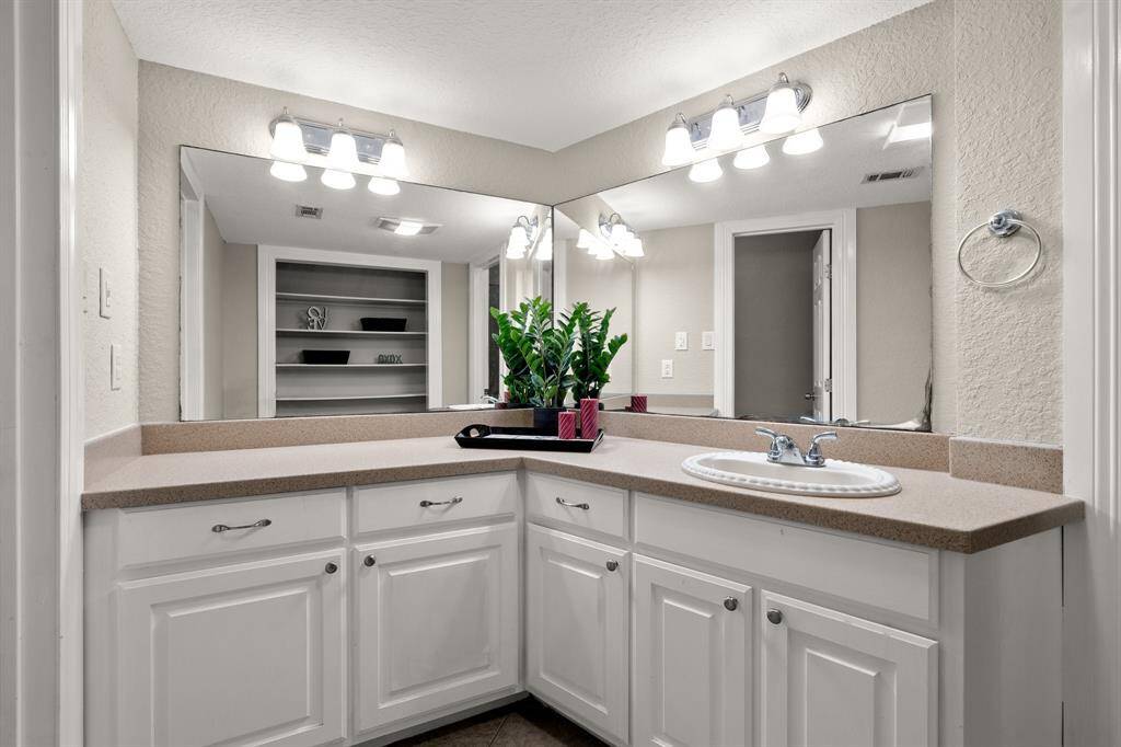 Large second bathroom with plenty of counter and storage space, perfect for family members or guests.