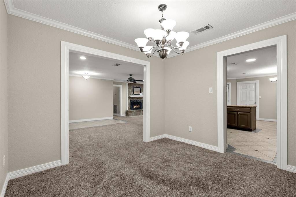 View from the formal dining room into the living area and kitchen