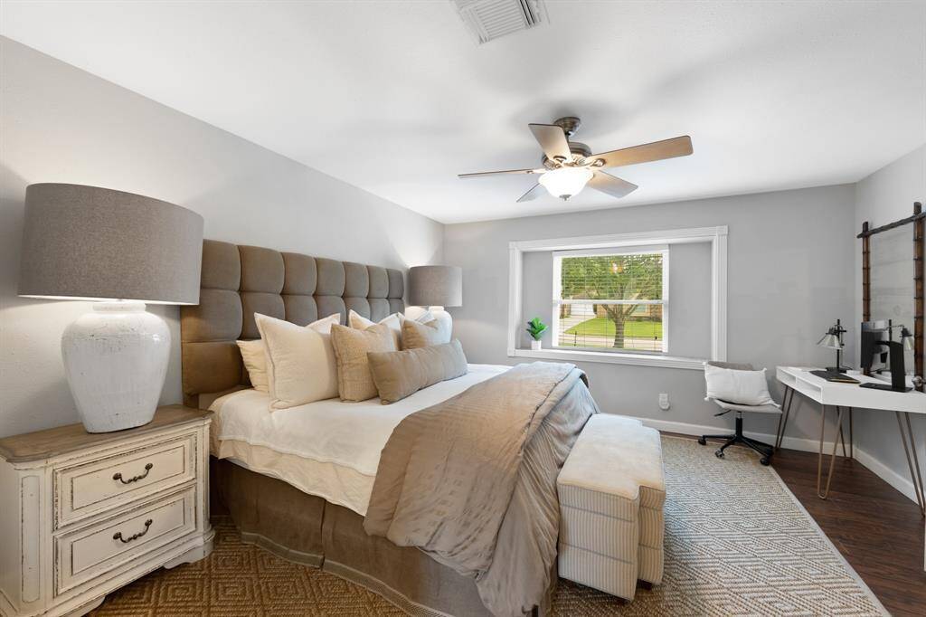 A charming framed sitting window fills the primary bedroom with abundant natural light.