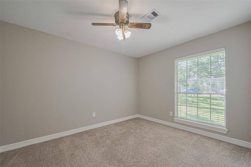 2nd bedroom offers natural lighting from a large window, fan, and ample-sized closet