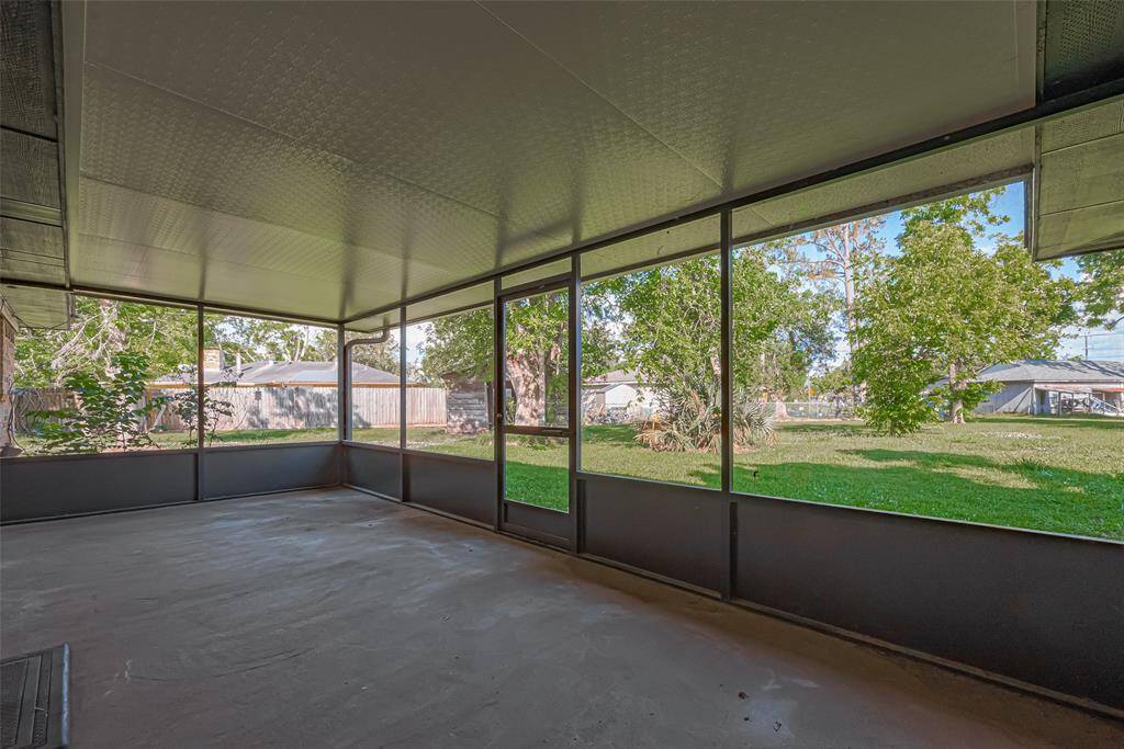 Leading out of living area, covered back patio offers plenty of space for outdoor activities and relaxation, with a view of the backyard through screened panels.  Enjoy the beauty of your backyard rain or shine!