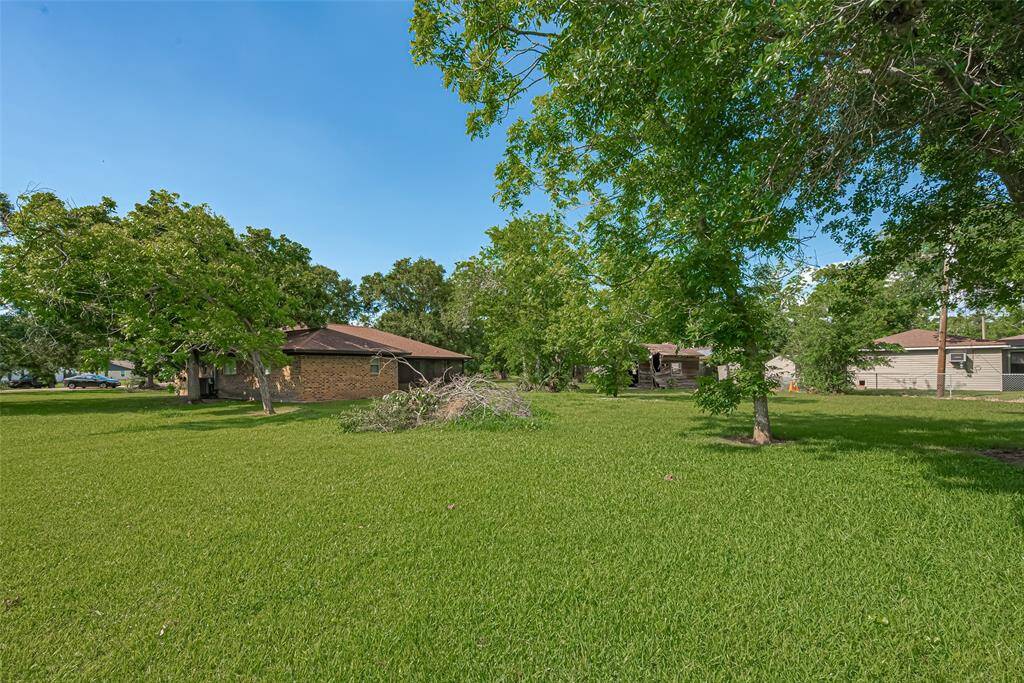 Leading out of living area, covered back patio offers plenty of space for outdoor activities and relaxation, with a view of the backyard through screened panels.  Enjoy the beauty of your backyard rain or shine!