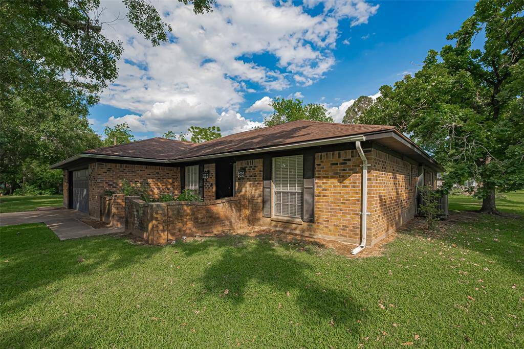 Charming brick home with a spacious, well-maintained lawn and mature trees, providing ample shade and privacy. Ideal for outdoor relaxation and family gatherings.