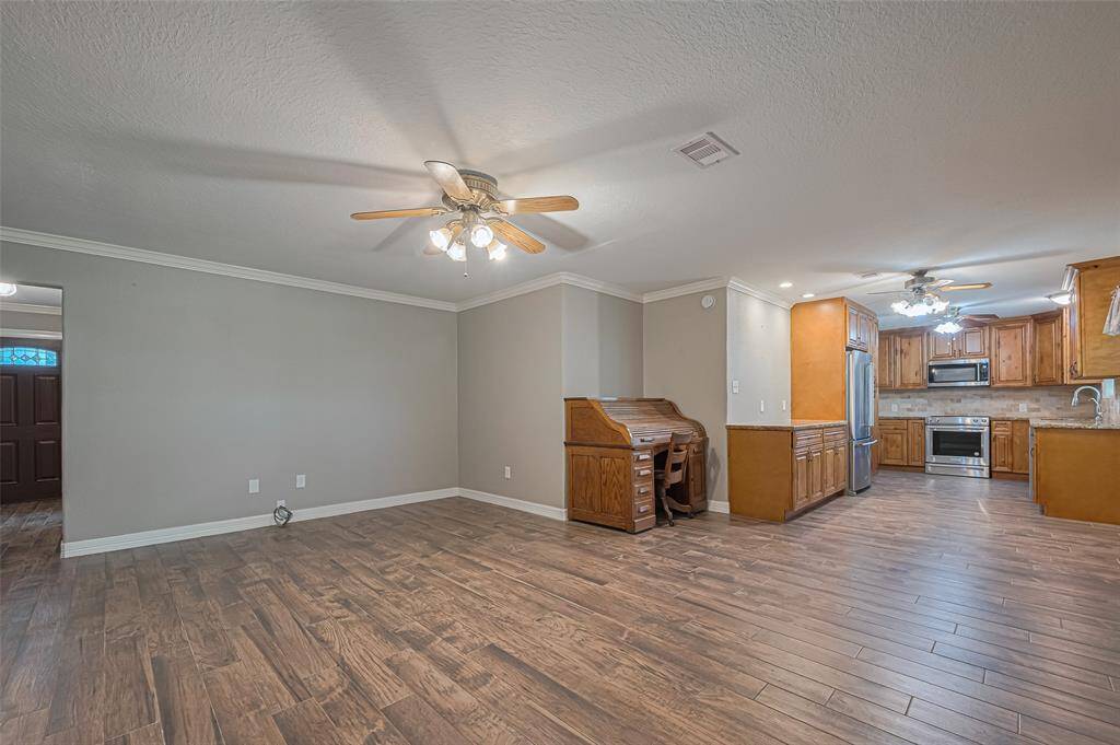 Large living area flows freely into dining area and kitchen, perfect for entertaining or family gatherings